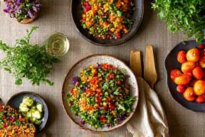 Colorful vegan feast with fresh local produce and herbs